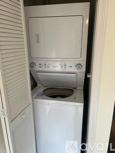 A white dishwasher and dryer are in a small space.