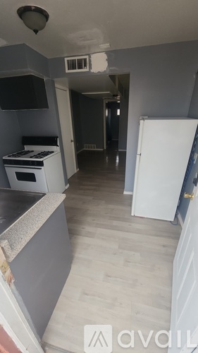 A kitchen with a white fridge and a white oven.