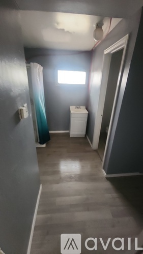 A bathroom with a toilet, sink, and shower.