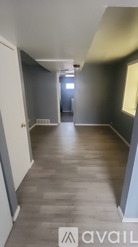 A long, narrow hallway with a light at the end.