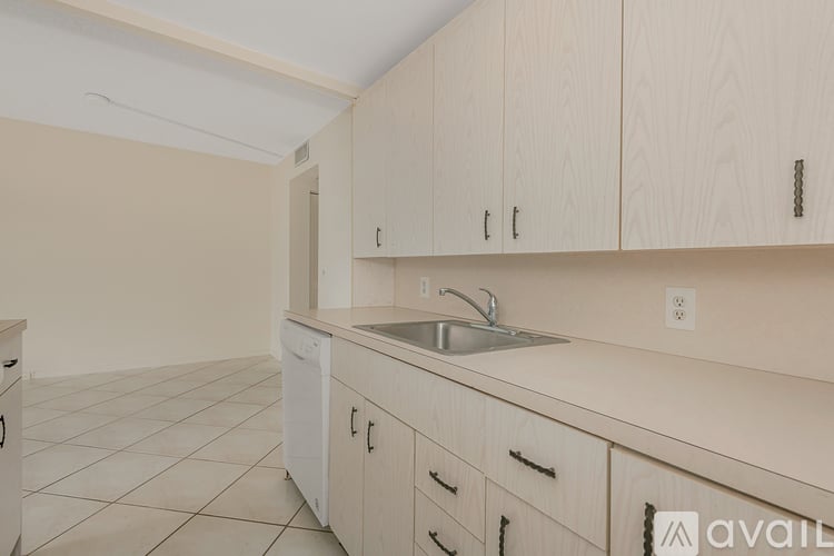 A kitchen with wooden cabinets and a white sink.