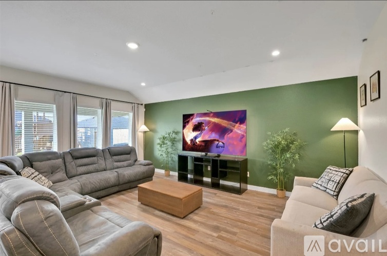 A living room with a grey sofa and a wooden coffee table.
