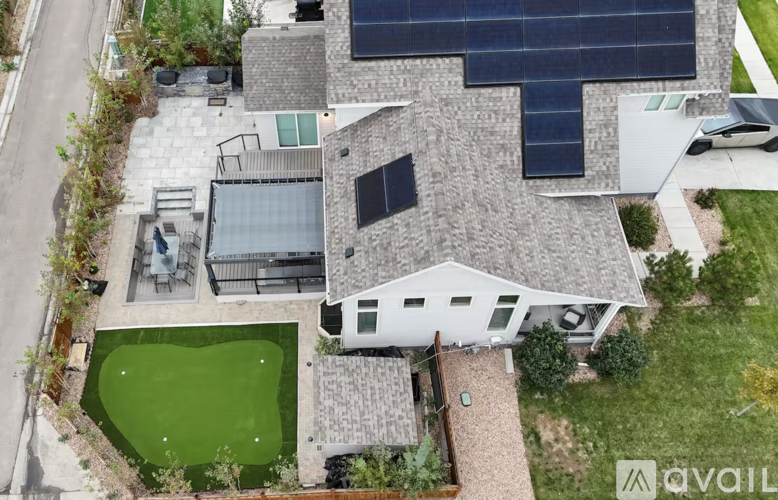 A house with a green lawn and a white exterior.
