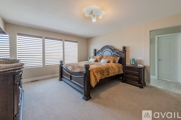 A bedroom with a large bed and a dresser.