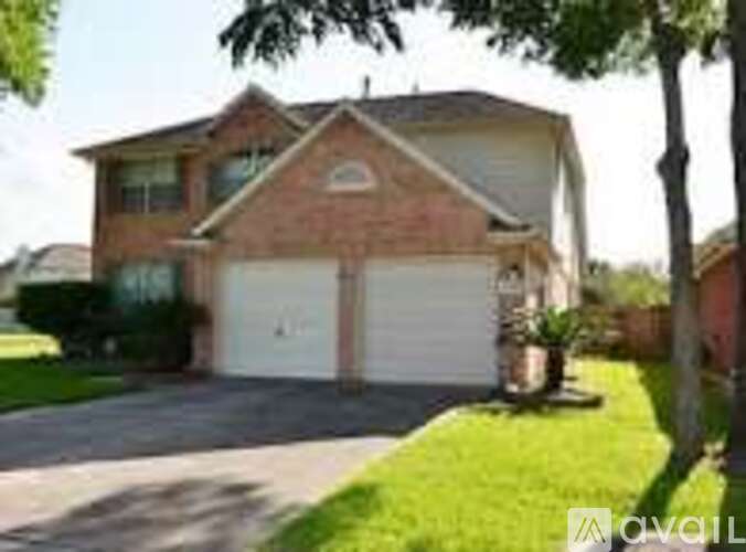 A two-car garage is attached to a brick house.