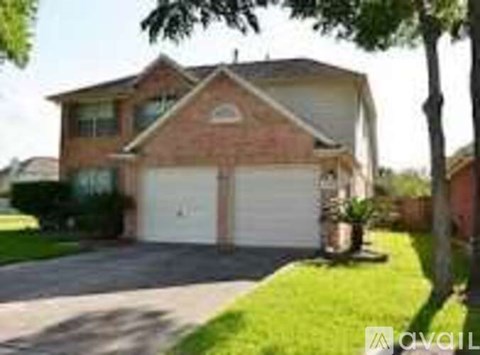 A two-car garage is attached to a brick house.