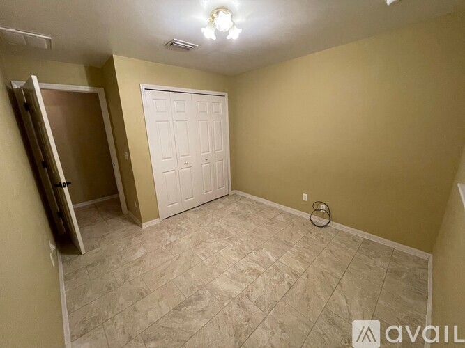 A room with a tiled floor and a white door.