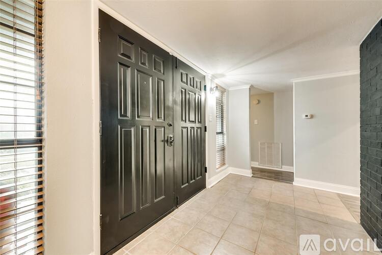 A black door with a glass panel is on the left side of the image.