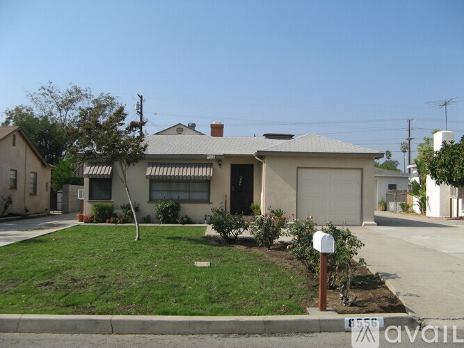 A house with a grey roof and a garage door.