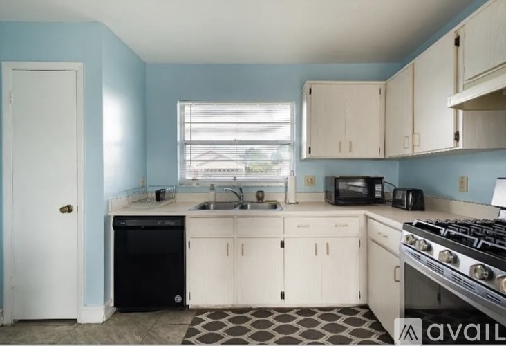 A kitchen with blue walls and white appliances.