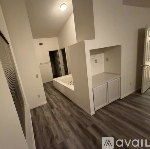 A room with a bathtub and a vanity in a house under construction.