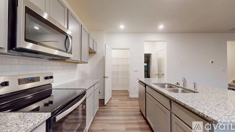 A modern kitchen with a stainless steel oven and microwave.