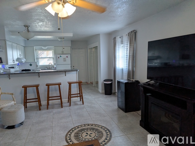 A living room with a bar and a television.