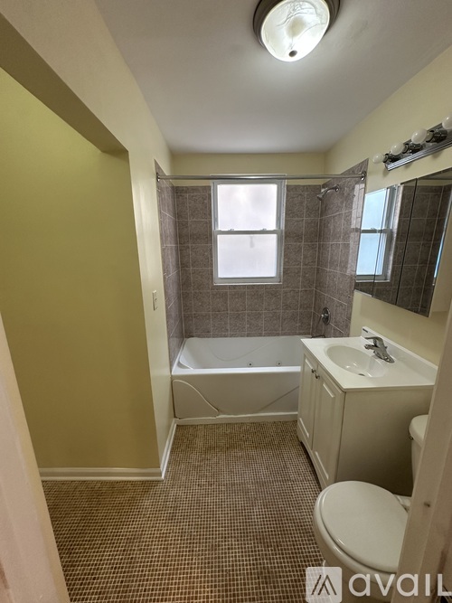 A bathroom with a toilet, sink, and bathtub.