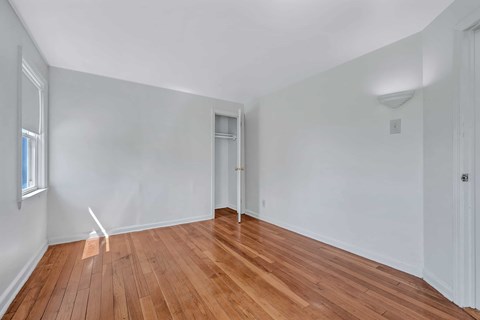 A room with wooden floors and white walls.