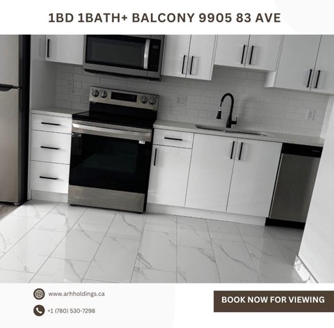 A kitchen with white cabinets and a black stove top oven.