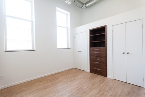 A room with a brown door and white walls.