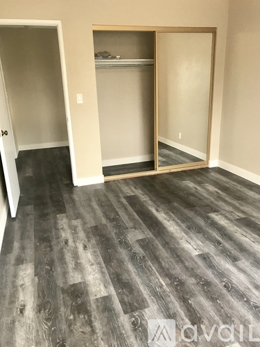 A room with a grey floor and a white door.