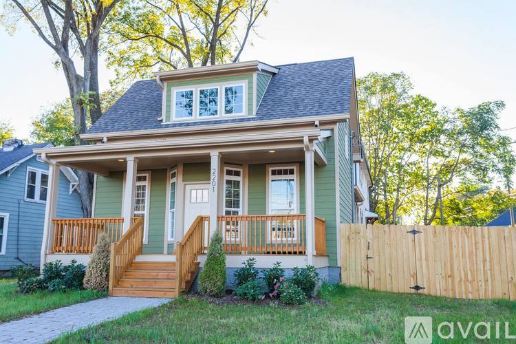 A house with a blue exterior and a wooden fence.
