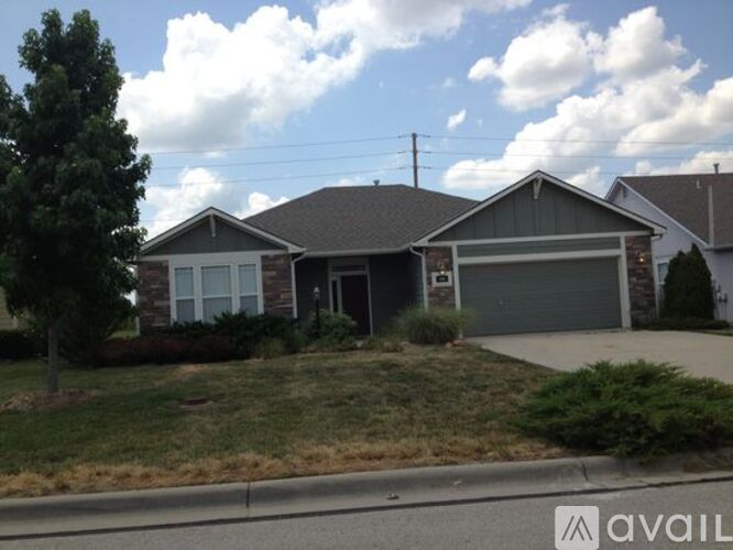 A house with a garage is for sale.