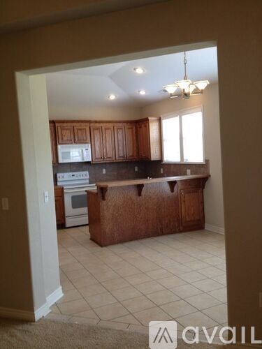 A kitchen with wooden cabinets and a white oven.