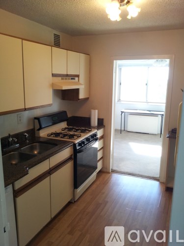 A kitchen with a stove top oven and a sink.