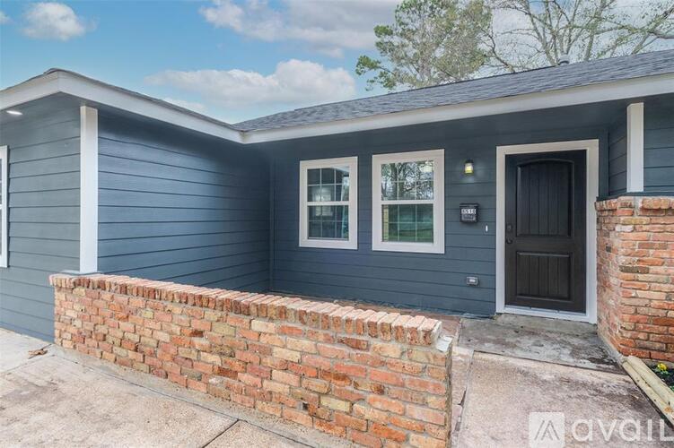 A house with a grey exterior and a black door.