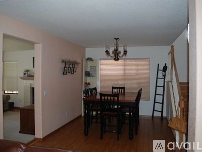 A dining room with a table and chairs.