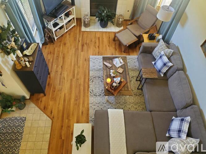 A living room with a grey couch and a coffee table.