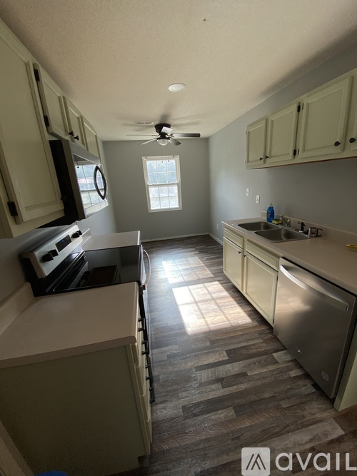 A kitchen with a stove top oven and a refrigerator.