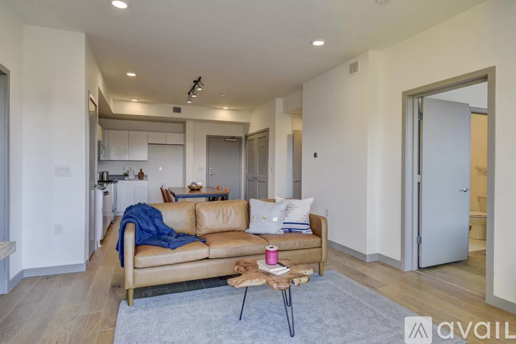 A living room with a couch, a chair, and a coffee table.