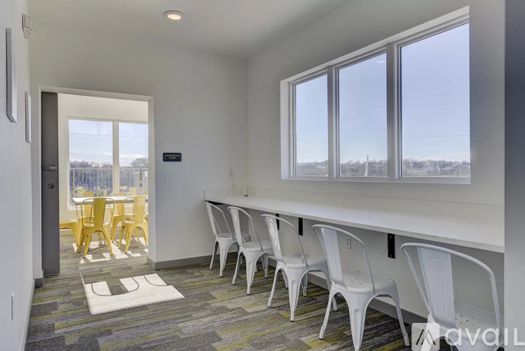 A conference room with a long table and chairs.