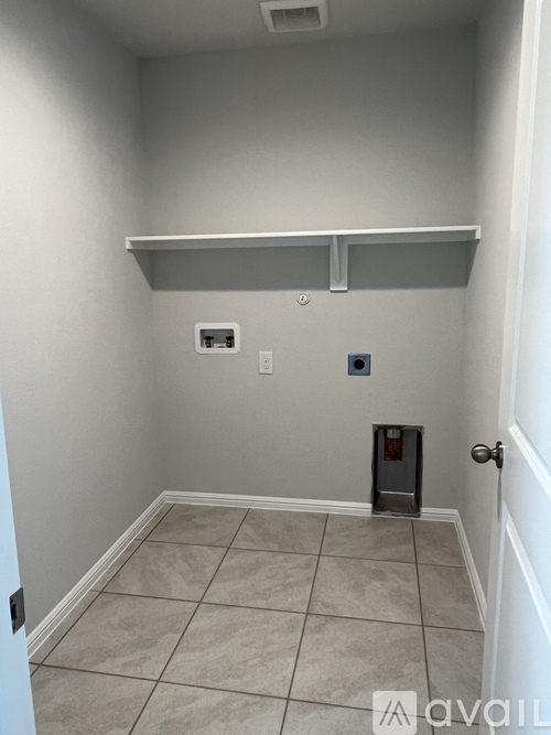 A room with a tiled floor and a white door.