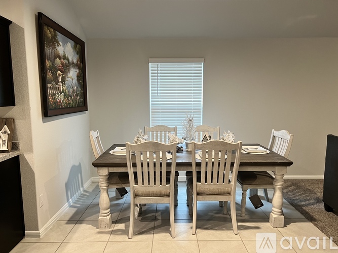 A dining room with a wooden table and chairs.