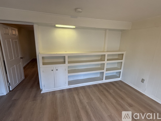 A room with a white cabinet and a light on.
