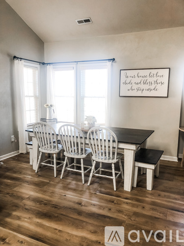 A dining room with a table and chairs.
