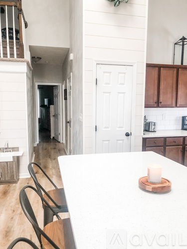 A white table with a candle on it in a kitchen.
