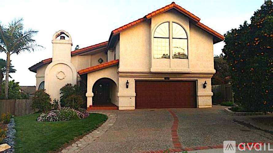 A house with a red tiled roof and a large arched window.