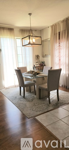 A dining room with a table set for four.