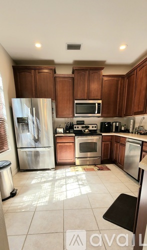 A kitchen with wooden cabinets and stainless steel appliances.