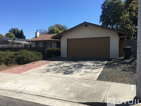 A house with a brown garage door and a driveway.