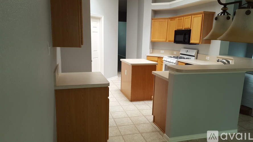 A kitchen with wooden cabinets and a white countertop.
