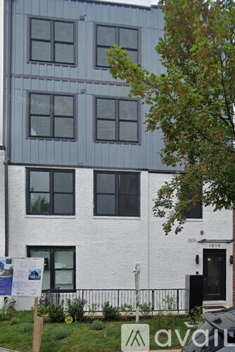 A white building with a black door and windows.