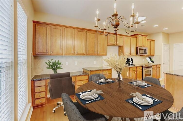 A dining room with a wooden table set for four.