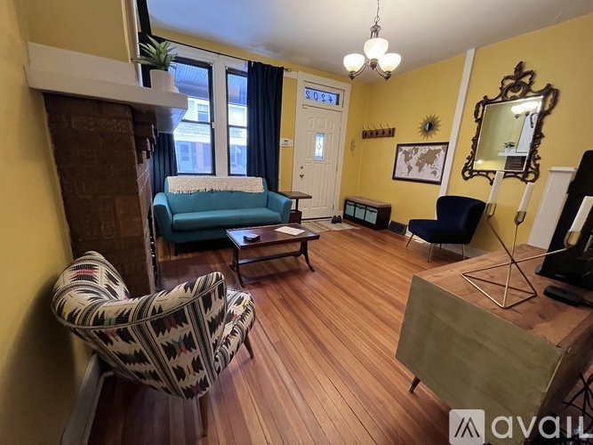 A living room with a blue chair and a patterned chair.
