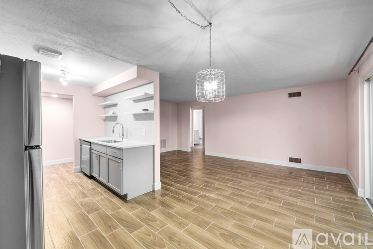 A kitchen with a refrigerator, sink, and cabinets is available for rent.