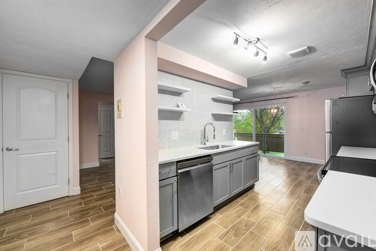 A kitchen with a white door and a white counter.