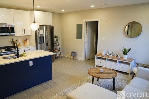 A modern kitchen with blue cabinets and a white countertop.