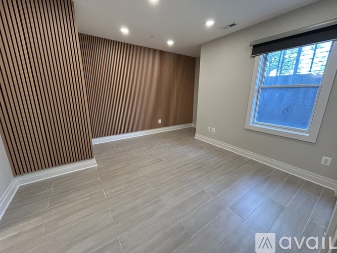 A room with wooden striped wall and a window.