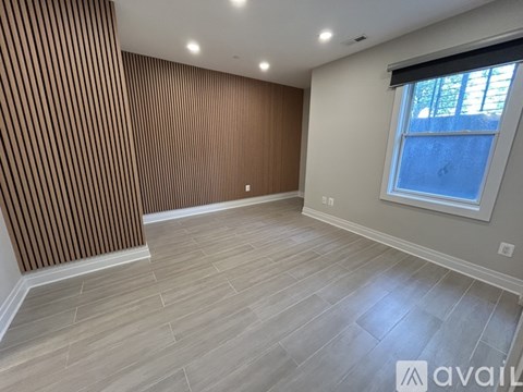 A room with wooden striped wall and a window.
